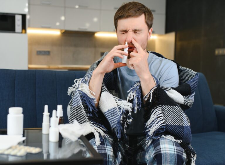 sick man nasal spray tissue blanket winter smaller- Depositphotos_658301476_XL